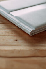 The image is a close-up shot of a book placed on a wooden table indoors 6130.