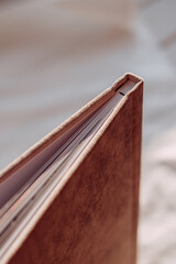 The image is a close-up shot of a tan and brown book with a wooden binding 6174.