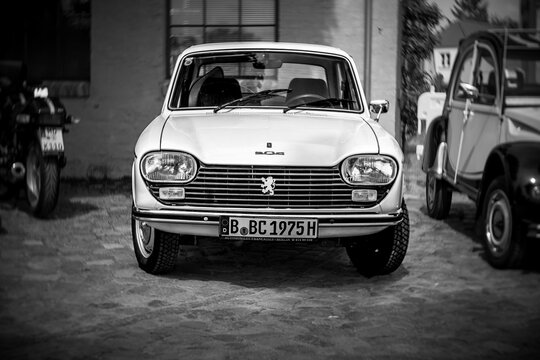 WERDER (HAVEL), GERMANY - MAY 20, 2023: The small family car Peugeot 204. Swirl bokeh. Art lens. Black and white. Oldtimer - Festival Werder Classics 2023