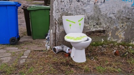 Old Toilet Bowl Dumped Outdoors during Apartment Renovation for Curb Side Pickup by City Cleaning Service Fixed