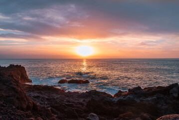 Beautiful landscape of a magnificient sunset over the Atlantic Ocean coastline in Fuerteventura island, on Las Palmas de Gran Canaria.