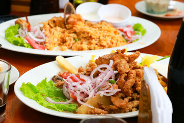 Peruvian Gastronomy: Fish Chicharrones and Seafood Rice Symphony