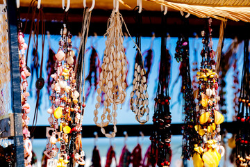Handmade beach style jewelry and colorful bracelets for sale to tourists at the beach market