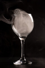 Crystal glass, beautiful Crystal glass with smoke on black background, selective focus.