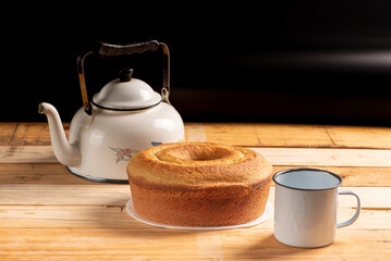 Orange cake, beautiful orange cake and accessories on rustic wood and black background, selective focus.