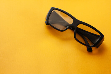 3d glasses on a yellow background, watch a movie