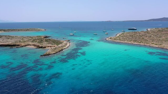 Aerial drone video of azure paradise blue lagoon of Panteronisi a small islet complex between Paros and Antiparos islands, Cyclades, Greece
