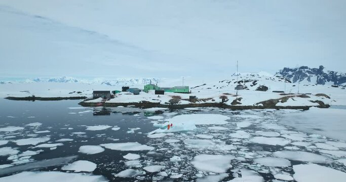 Antarctica polar science station, people explore ice movement, weather, and environmental conditions of global climate change. Scientific research wildlife, expedition to South Pole. Aerial drone shot