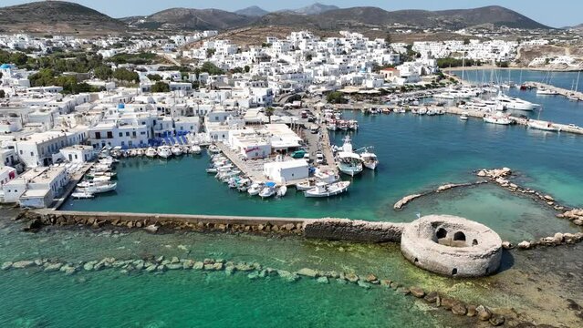 Aerial drone video from picturesque small seaside village of Naoussa with traditional Cycladic character, Paros island, Cyclades, Greece