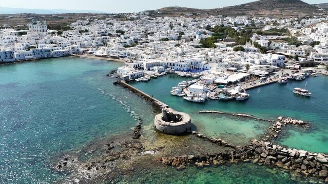 Aerial drone video from picturesque small seaside village of Naoussa with traditional Cycladic character, Paros island, Cyclades, Greece