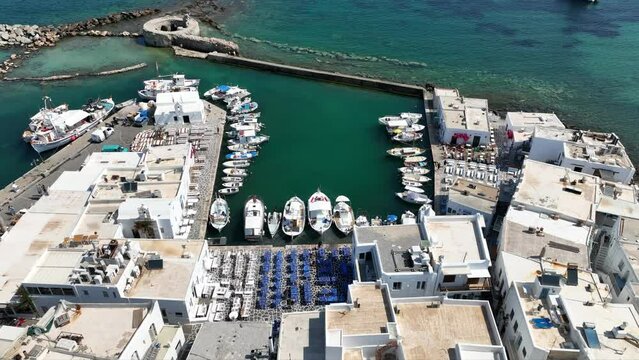 Aerial drone video from picturesque small seaside village of Naoussa with traditional Cycladic character, Paros island, Cyclades, Greece