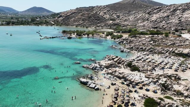 Aerial drone video famous small organised beach with unique rock formations of Kolimbithres or Kolympithres in the gulf of Naousa, Paros island, Cyclades, Greece