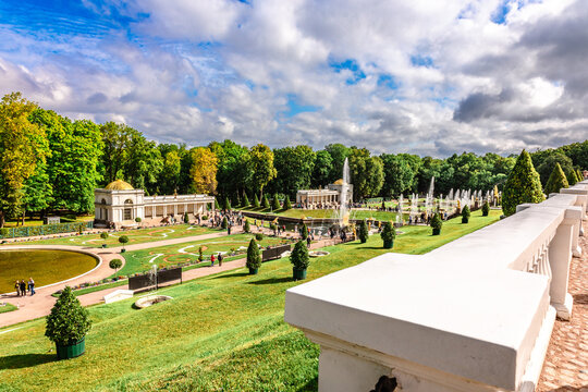 St. Petersburg, Russia - August 23, 2023: Fountains of Peterhof. View of Lower park of Peterhof. Beautiful garden with green grass, shrubs and flowers and decorative trees