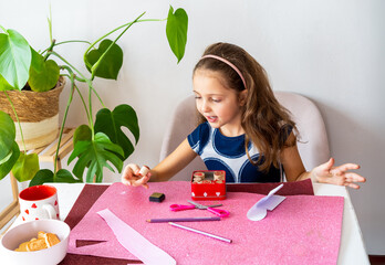 Surprised Child Engaged in Valentine's Day Arts and Crafts