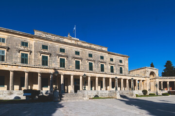 Fototapeta premium Corfu street view, Kerkyra old town beautiful cityscape, Ionian sea Islands, Greece, a summer sunny day, pedestrian streets with shops and cafes, architecture of historic center, travel to Greece
