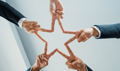 Business people collaborate business synergy and cooperation, join hand as star frame around empty...