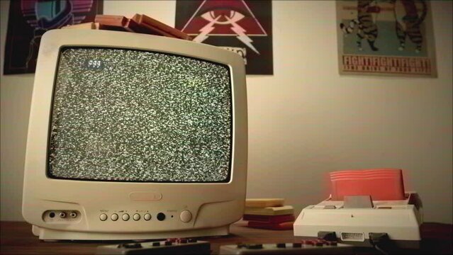 Old television with gray screen at home. Close-up of vintage tv in living room, nostalgia. Searching channel, bad signal. 