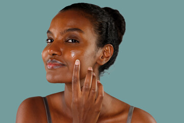 Gorgeous Black Woman Applying Moisturizing Cream