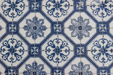 Blue traditional Portuguese ceramic tile pattern, azulejos. Beautiful shabby dirty facade, wall...