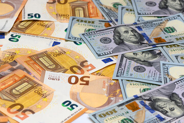 Fototapeta premium 50 euro and 100 dollar bills scattered on the table as a background 18