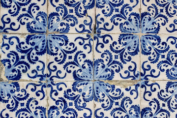 Closeup of decorative floral tiles. Blue traditional Portuguese ceramic tile pattern, azulejos. Beautiful shabby facade, wall decoration of old Lisbon building, Portugal. Decorative background. - obrazy, fototapety, plakaty