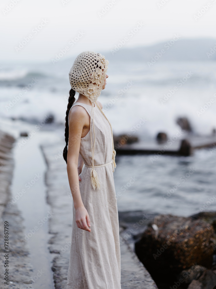 Sticker Solitude in the Summer: A Young Woman's Tranquil Beachwalk amidst Nature's Grace and Beauty