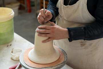 manual processing of clay in the ceramist's workshop