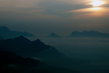 sun rise from the top of the mountains with mist