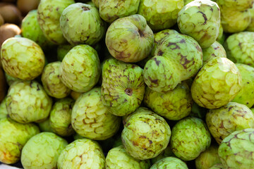 Fototapeta premium Organic chirimoya fruits or custard apples ready for sale in greengrocery