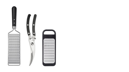 Aligned graters and poultry shears on white copy-space background.