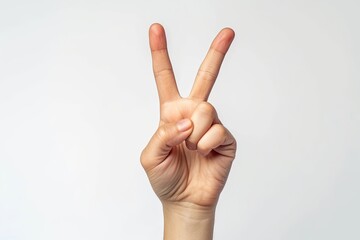 Hand making peace or victory sign representing V in sign language on white background
