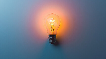 Horizontal image of glowing bulb on dark blue background with copy space