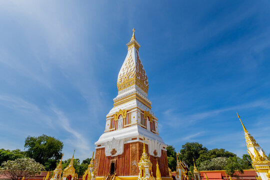 White gold pagoda with blue sky as background, Wat Phra That Phanom is a Buddhist temple in the That Phanom District in the south of Nakhon Phanom Province, Isan region of Thailand near the Lao border