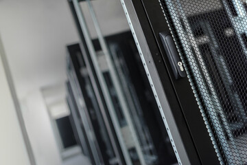 A close-up view of the door handle of an empty server rack.