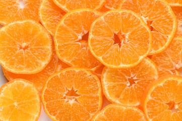 sliced ​​juicy appetizing tangerines as a food background 1