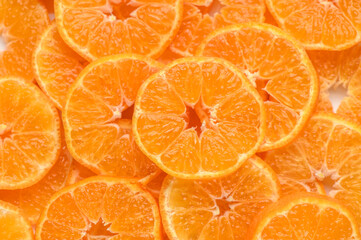 sliced ​​juicy appetizing tangerines as a food background 2