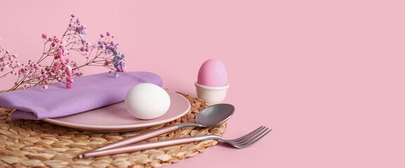 Beautiful festive table setting for Easter dinner on pink background with space for text