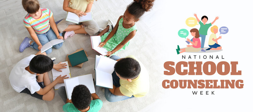 Little children reading books on floor