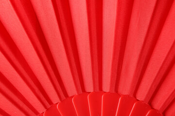 Closeup view of red paper fan as background