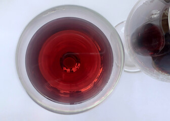 Glass of red wine from above on a white tablecloth