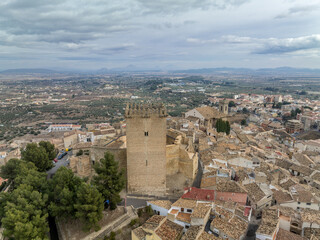 Fototapeta na wymiar Aerial view of Moratalla castle in Murcia province Spain dominating the village with square great tower, nicely restored monument from medieval times
