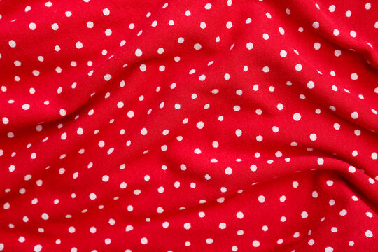Closeup view of red polka dot fabric texture as background