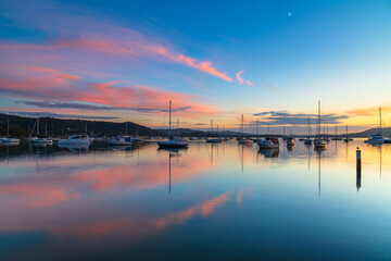 Fototapeta na wymiar Sunrise, boats and reflections on the water
