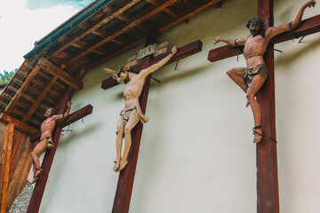 Jesus Christ and two martyrs crucifixion on wooden crosses in the Church of St. Leonard.Church of...