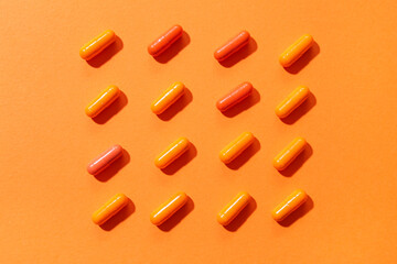 Many pills on orange background