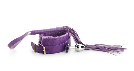 Purple collar with whip and anal plug from sex shop on white background