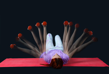 Young fitness trainer with dumbbells in motion on dark background