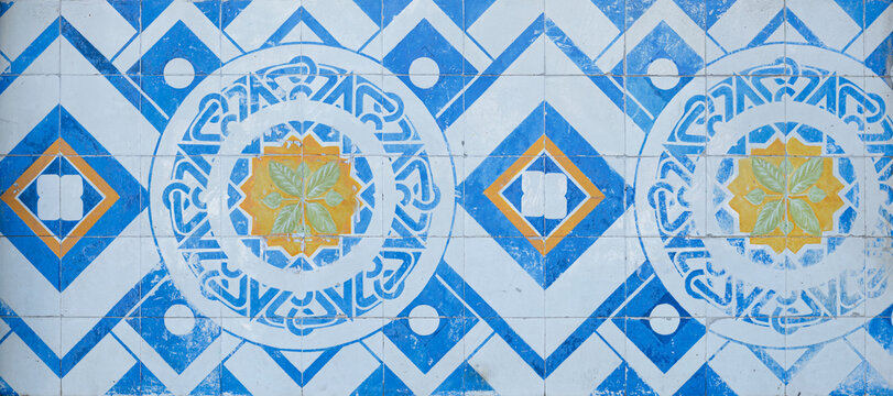 Classical style tiles mosaic in blue, yellow and white with greek inspiration 