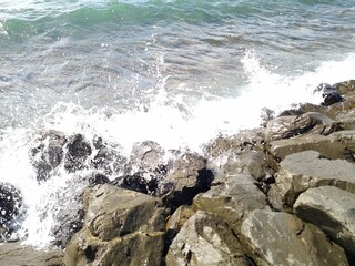 Raw waves crashing against the rocks in winter
