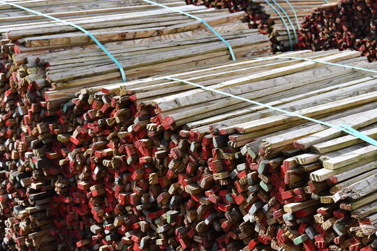 Bundles of sticks strapped together in lumber yard.